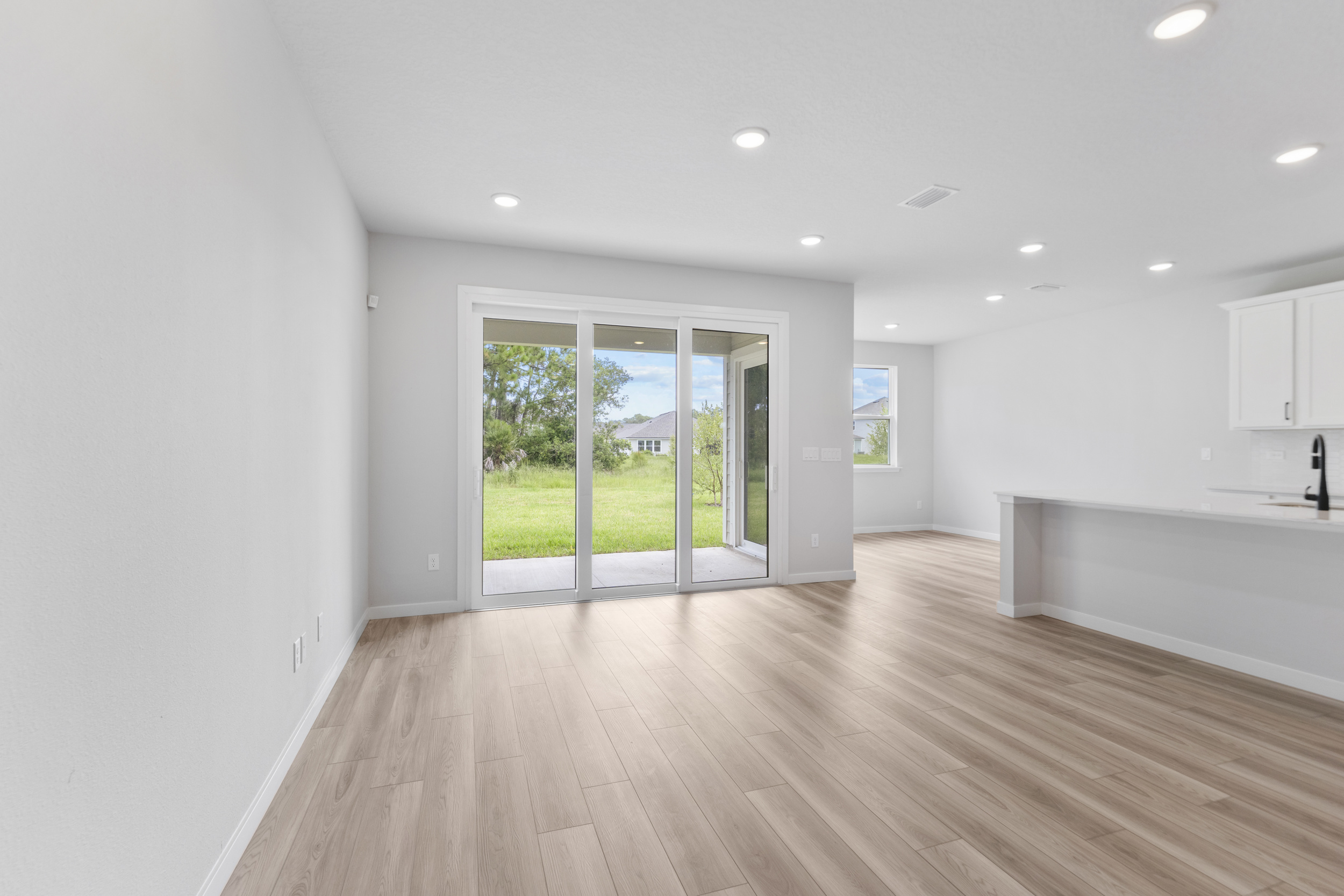 A room with a wood floor and a glass door.