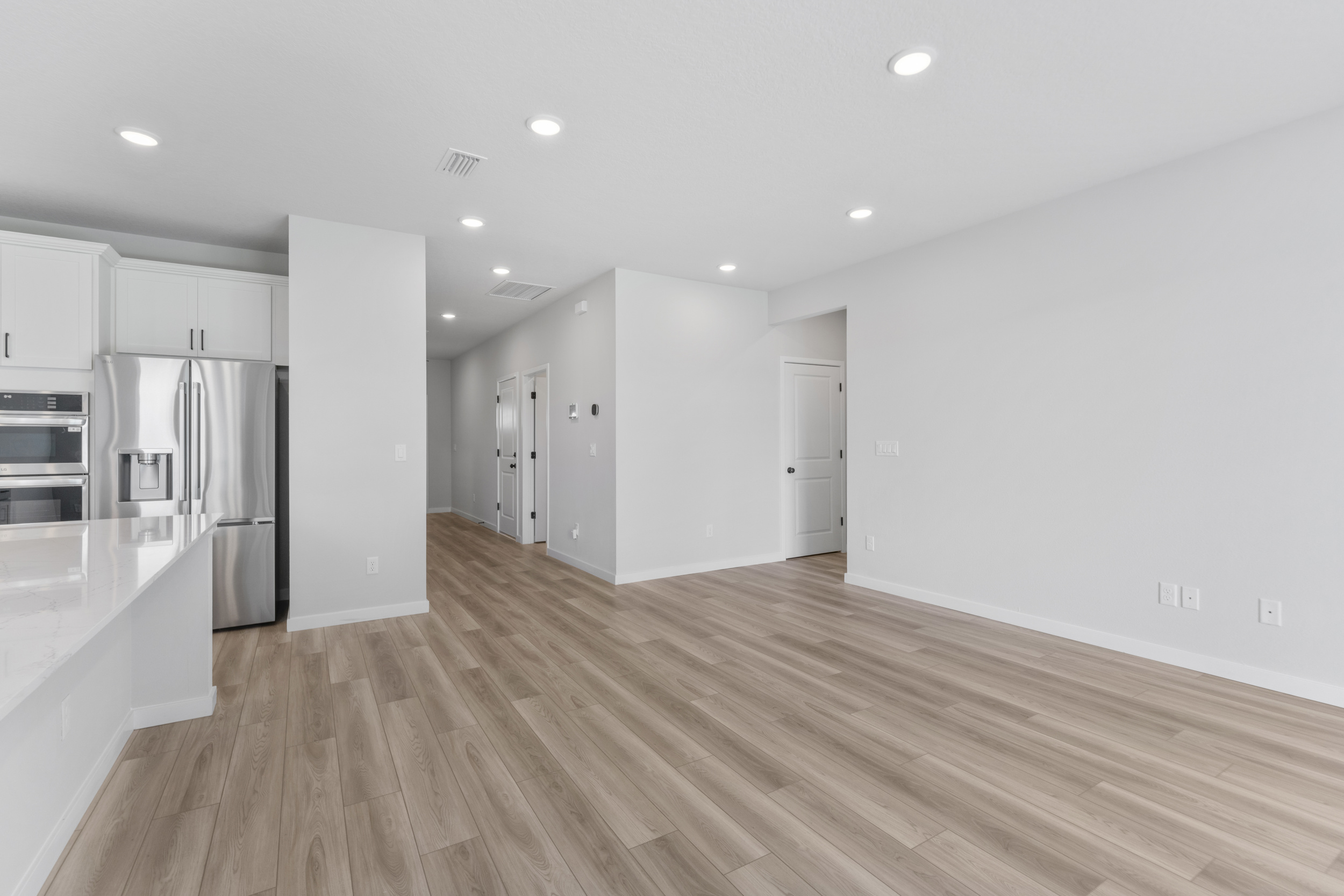 A kitchen with white cabinets.