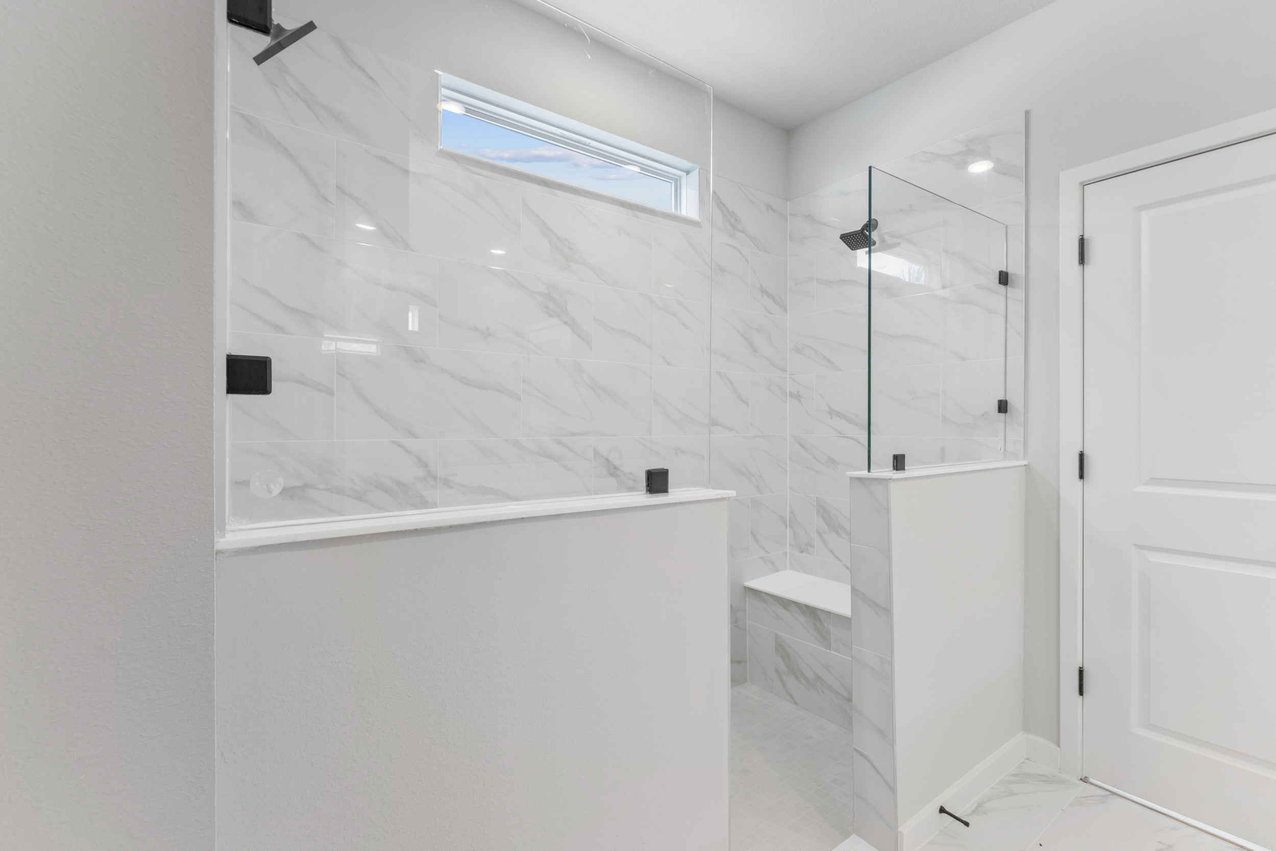A bathroom with a large mirror.