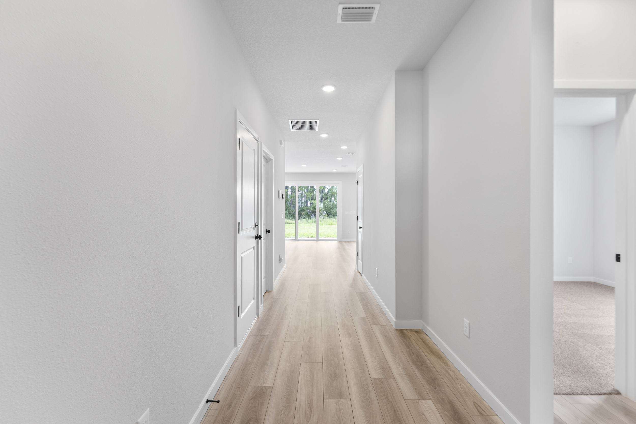A long hallway with white walls.