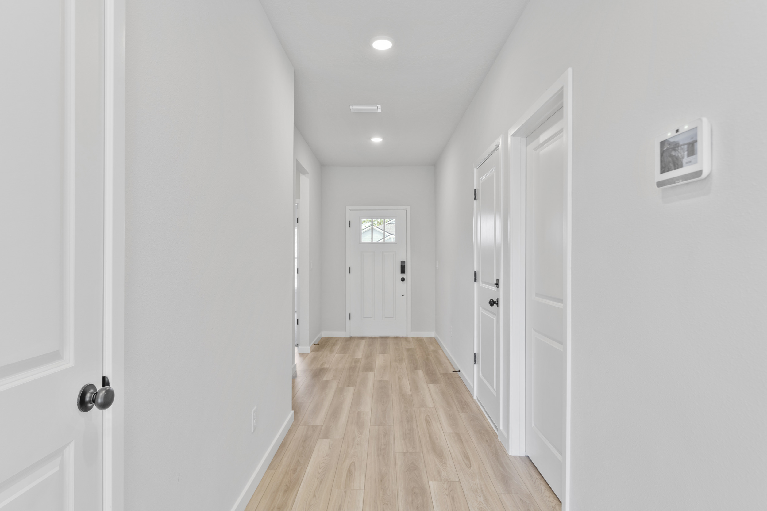 A hallway with white doors.