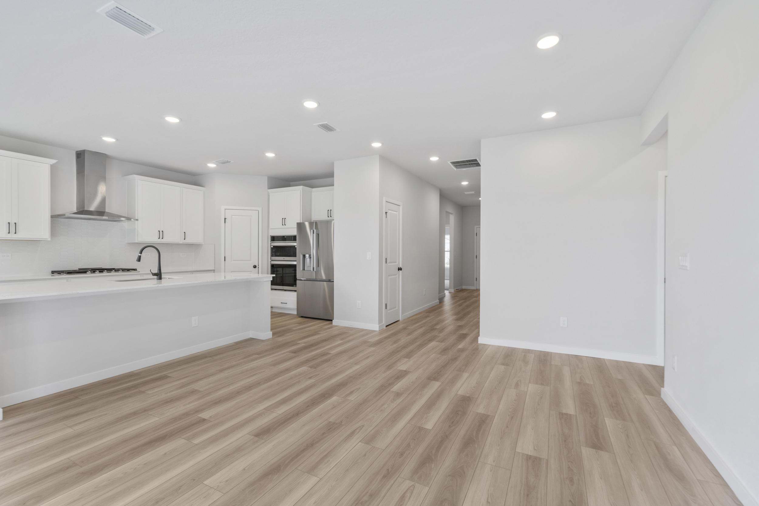 A kitchen with white cabinets.