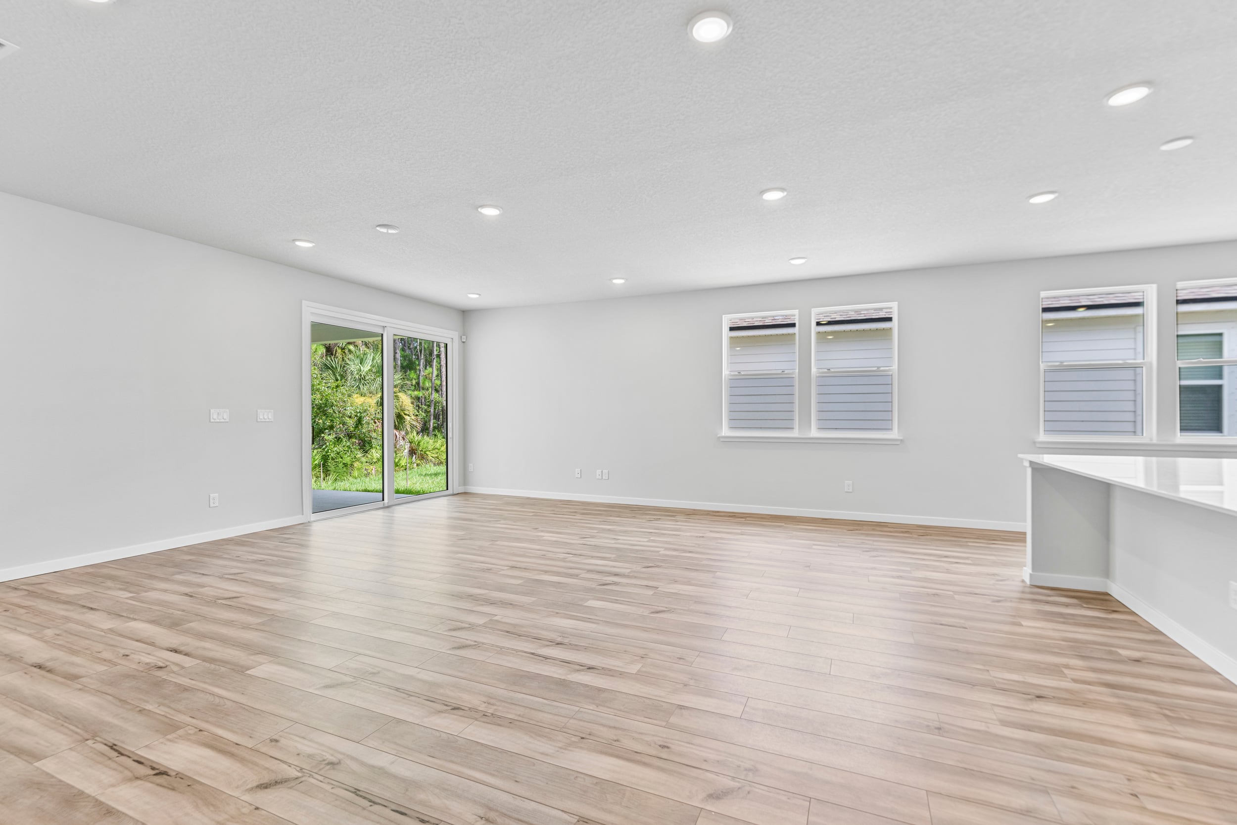 A room with a wood floor and windows.
