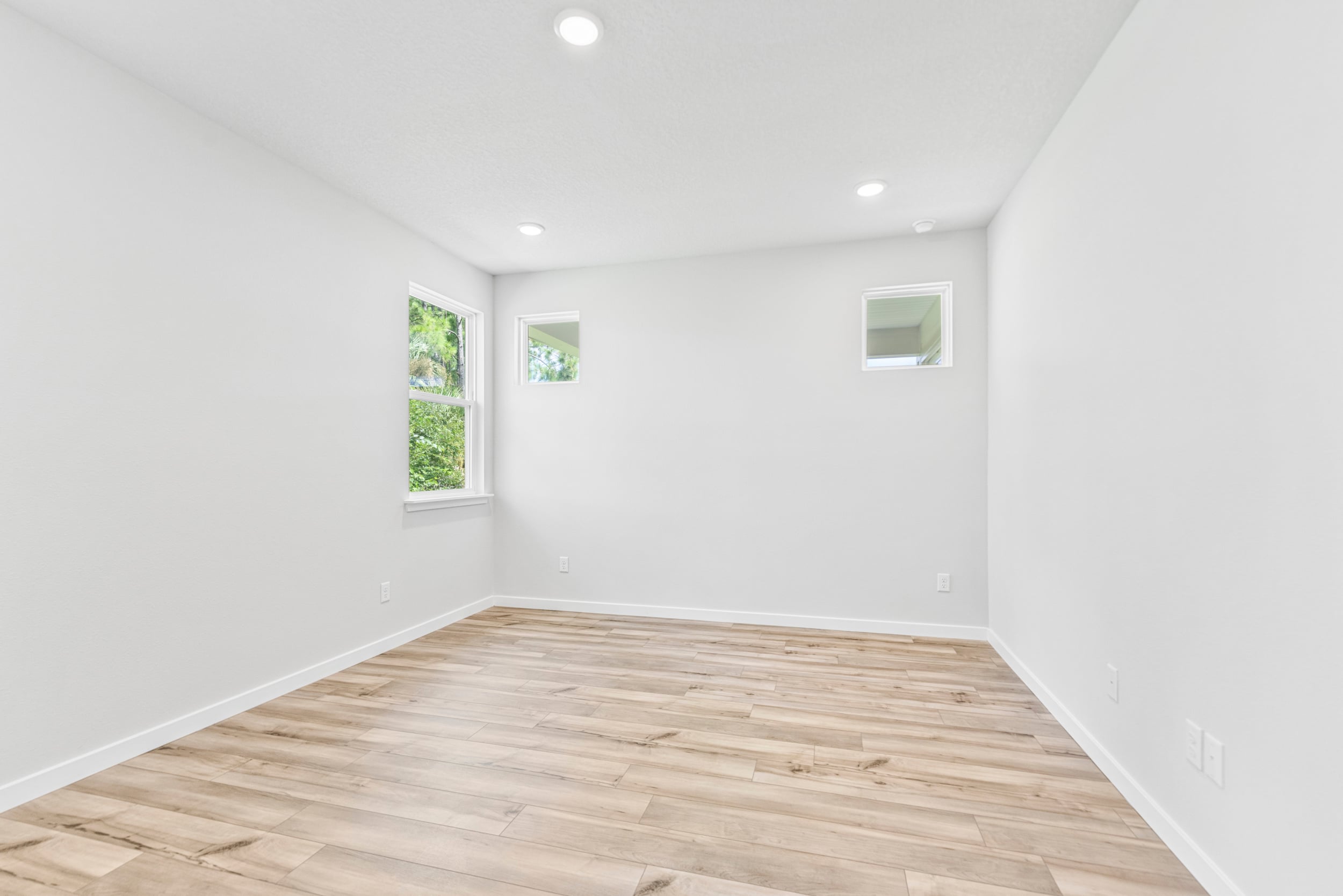 A room with a wood floor and a wood floor.