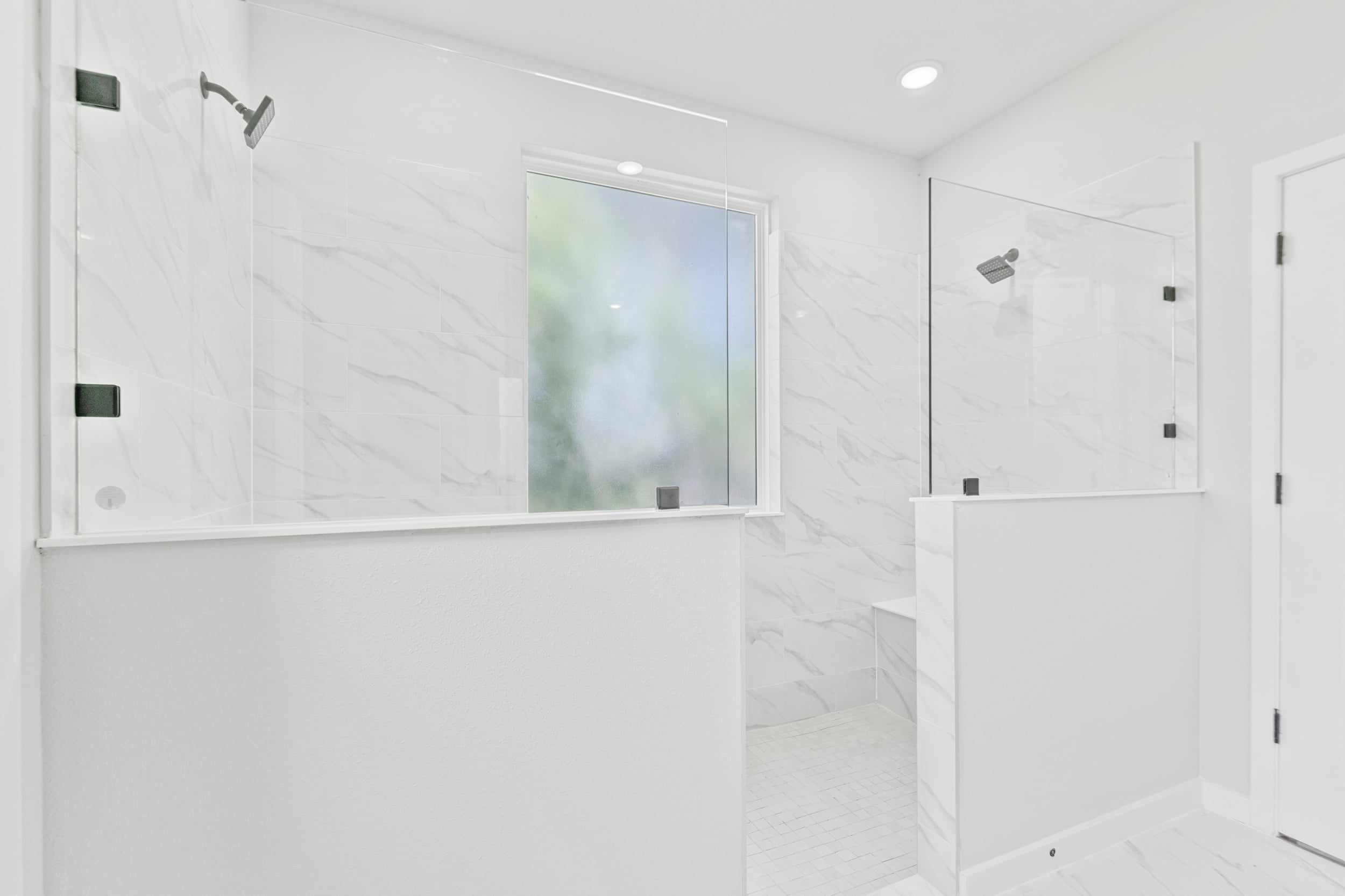 A white tiled room with a window.