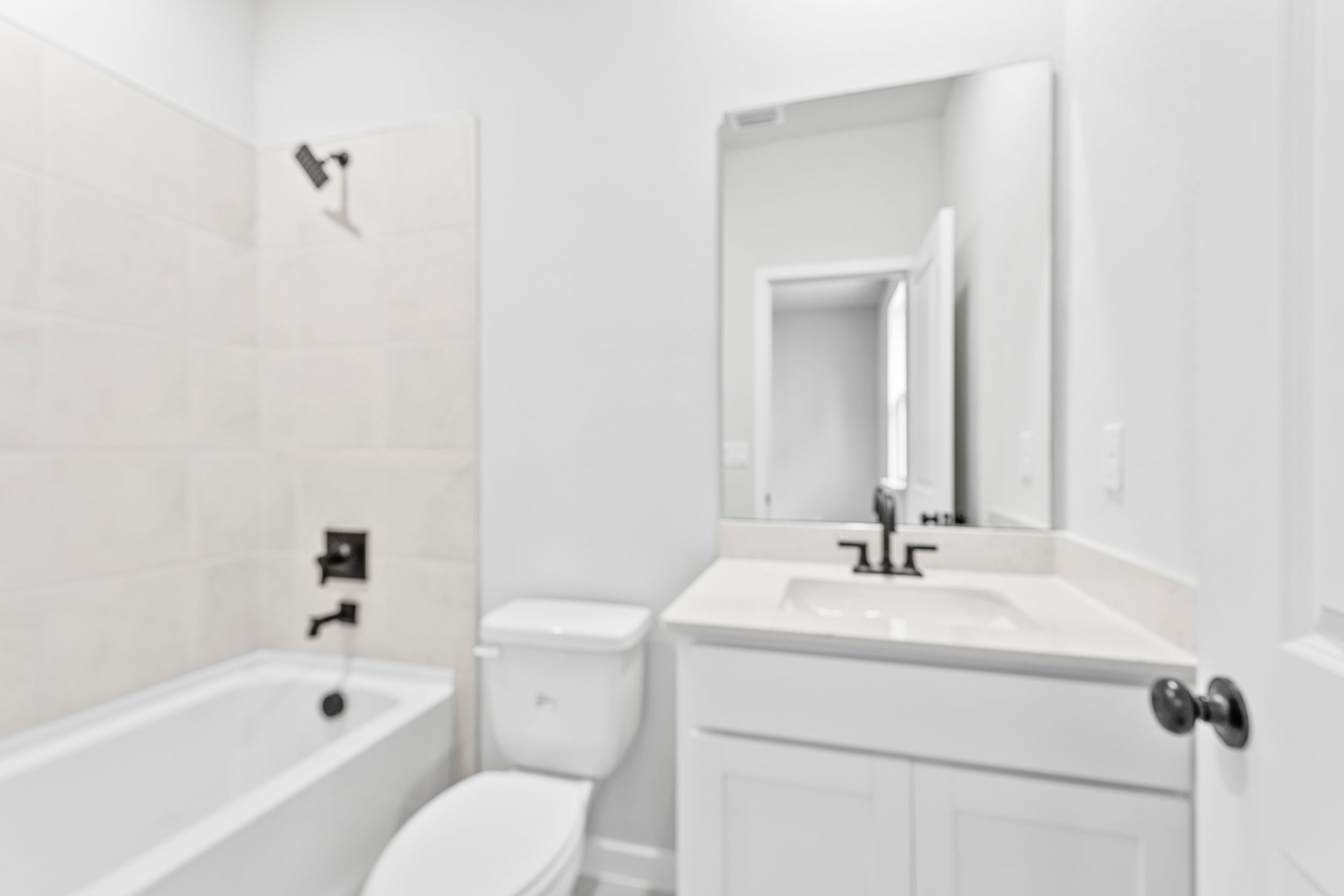 A bathroom with a tub sink and toilet.