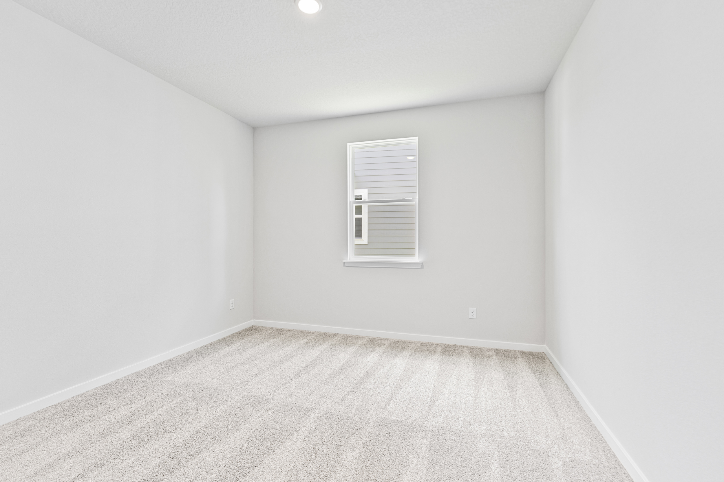 A white room with a window.