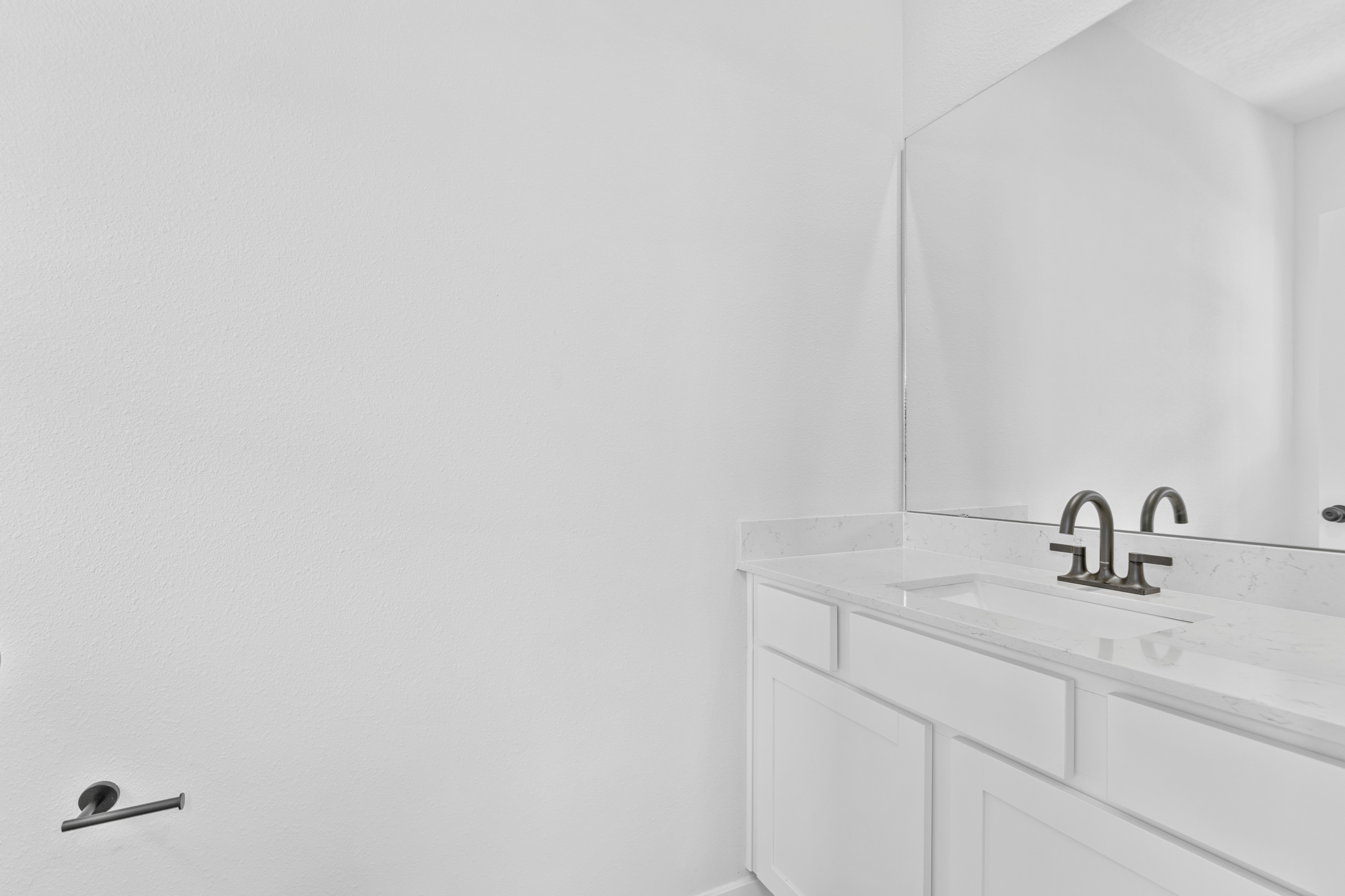 A bathroom with a mirror and sink.