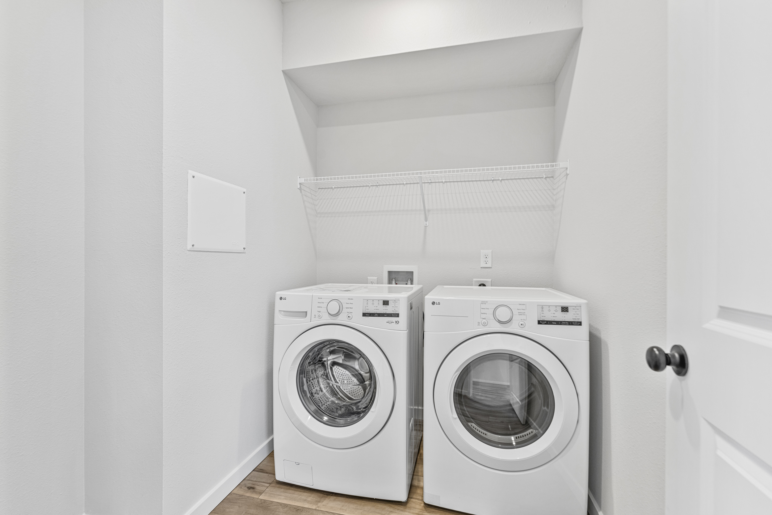 A washing machine and dryer in a room.