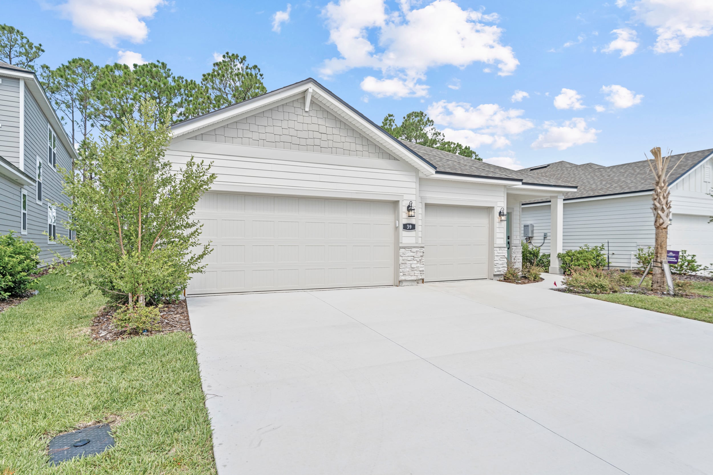 A white garage with a driveway.