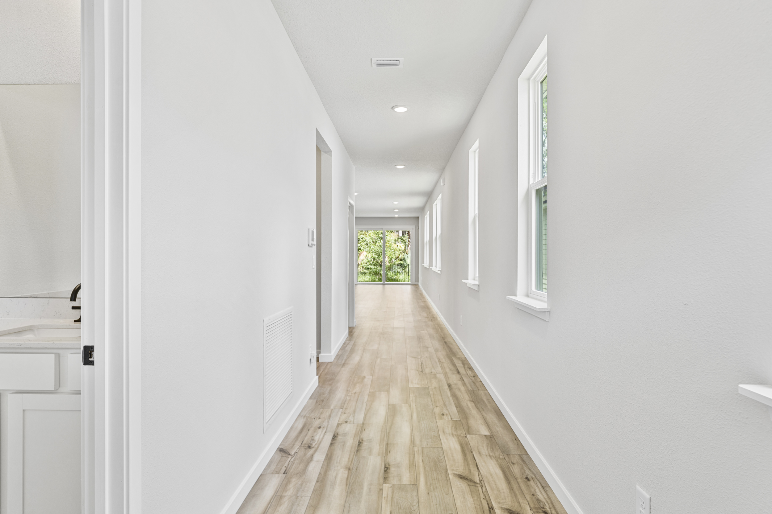 A long hallway with white walls.