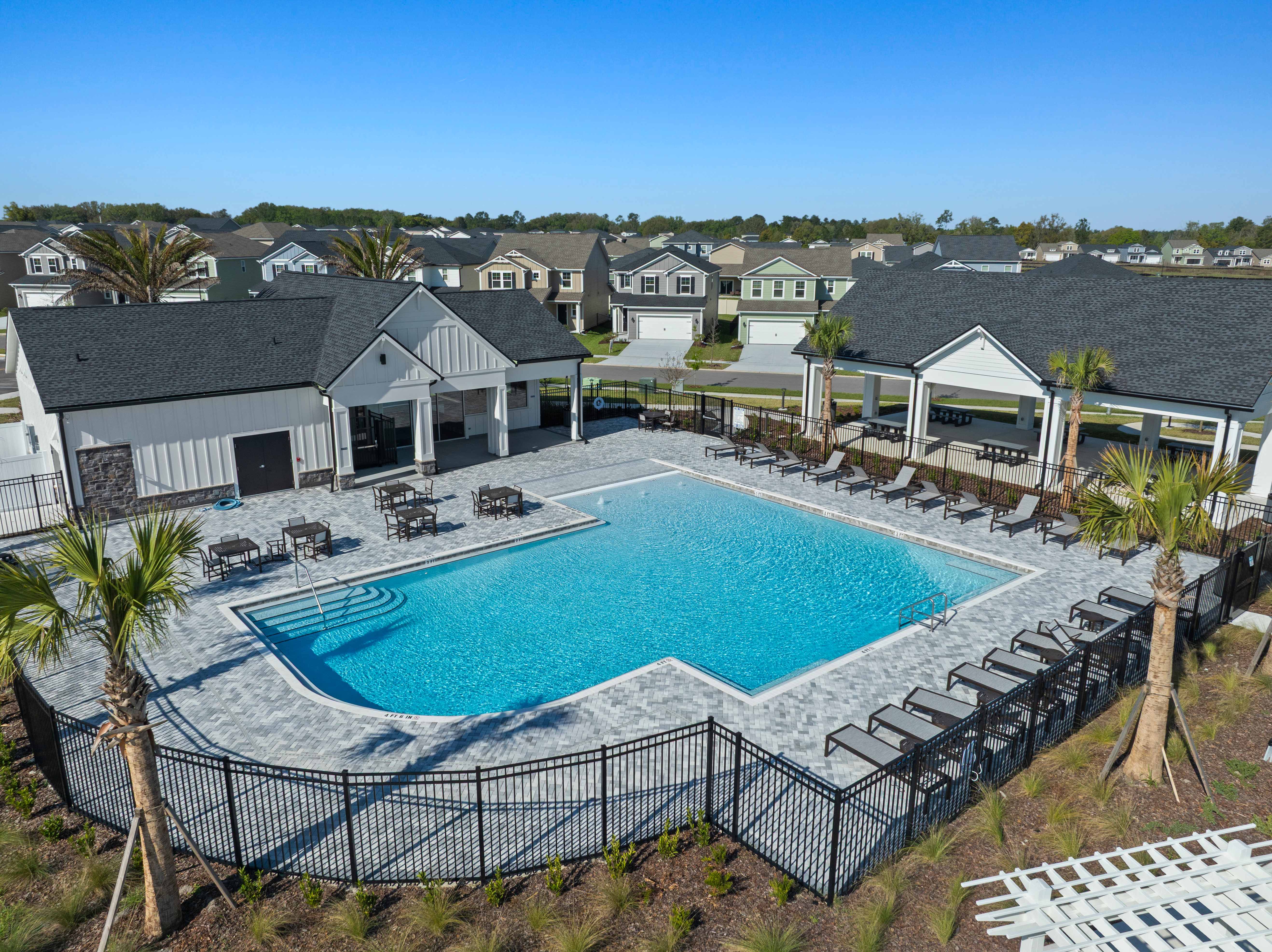 A swimming pool surrounded by houses.