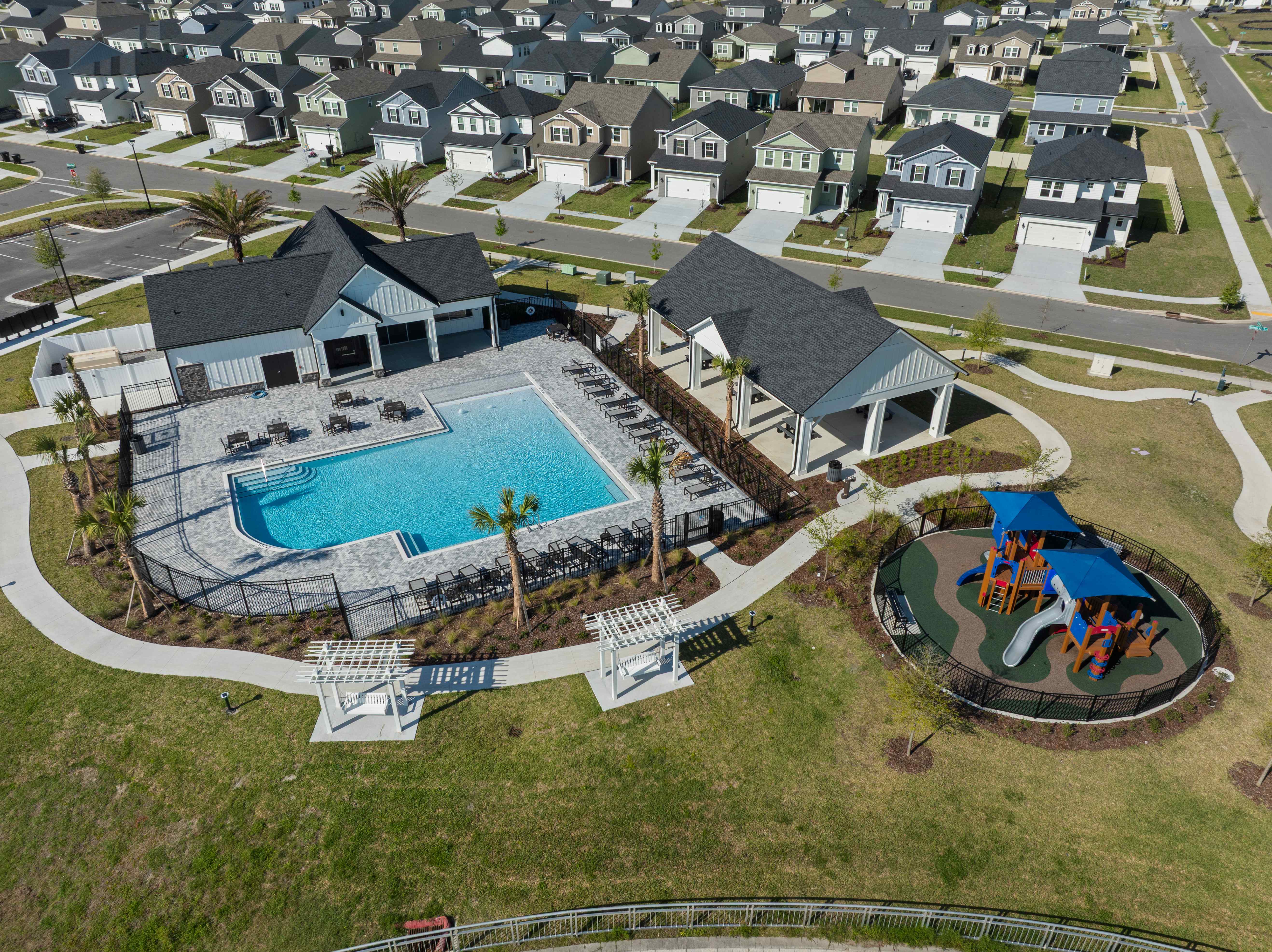 A large building with a pool in the middle of a field.