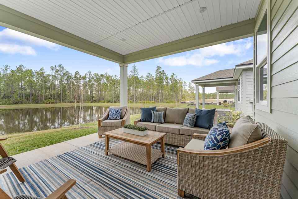 A deck with a pool and chairs.