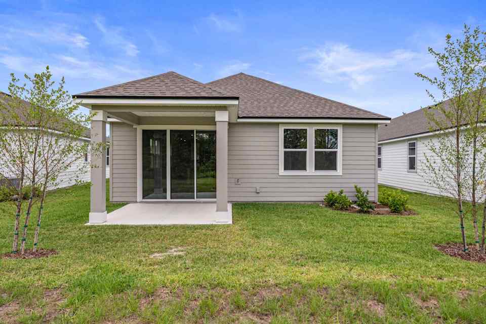 Sanibel II Floorplan Lot 143 Backyard with Covered Patio at Seminole Palms in Palm Coast