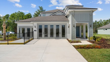 A white house with a driveway.
