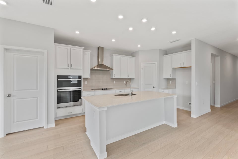 Palmetto Floorplan Lot 49 Chef's Kitchen with White Cabinets at Seminole Palms in Palm Coast