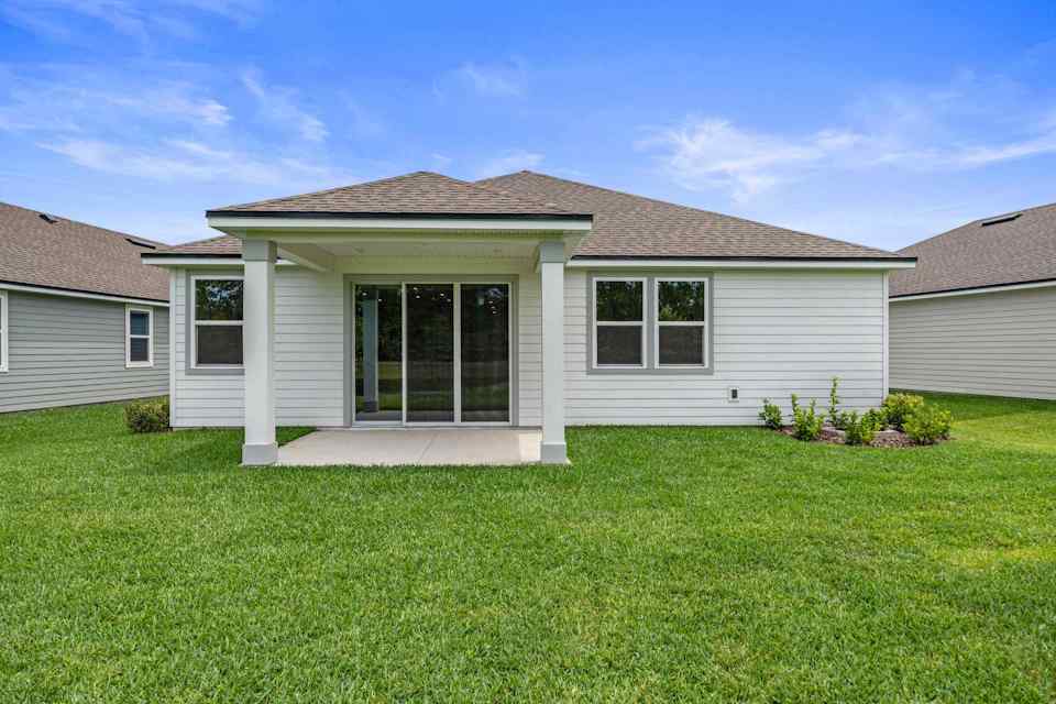 Charleston II Floorplan Lot 50 Backyard with Covered Patio at Seminole Palms in Palm Coast