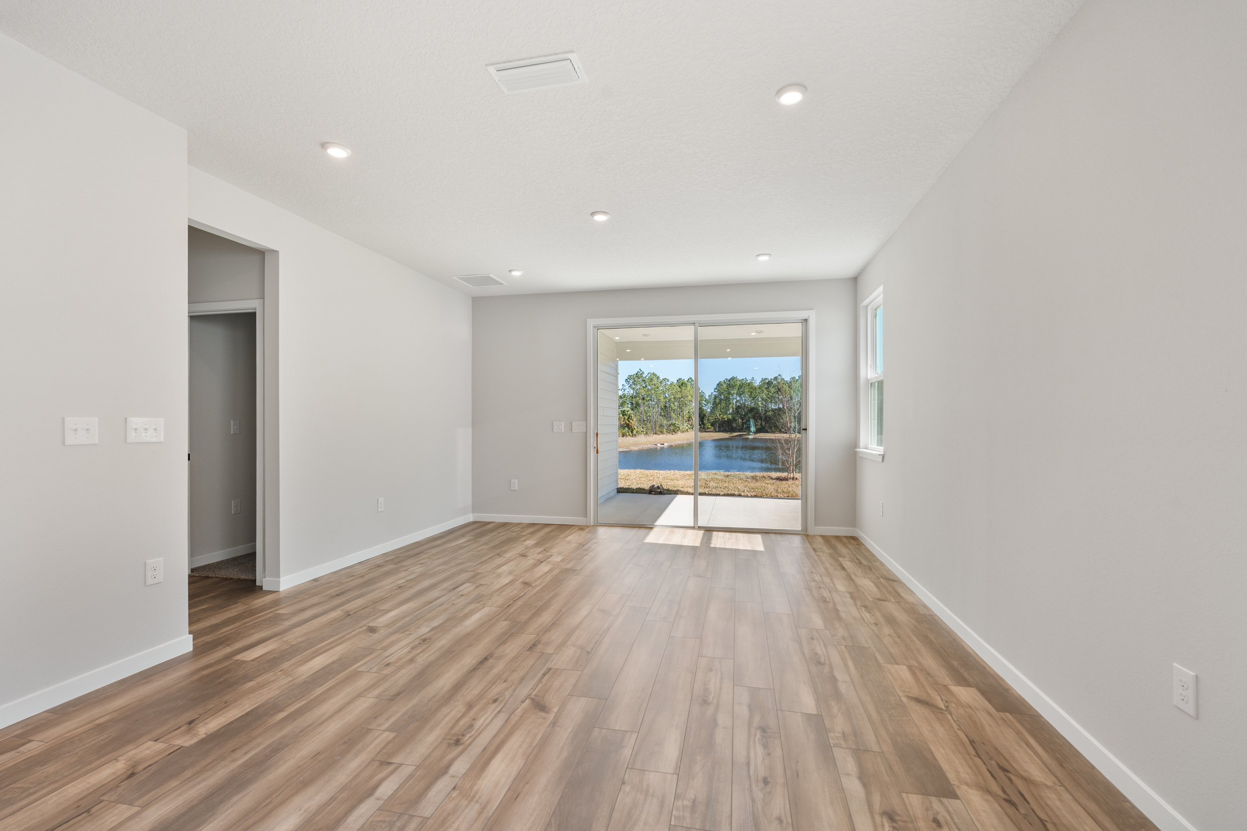 Lot 65 Great Room with Covered Patio and View of Water at Seminole Palms