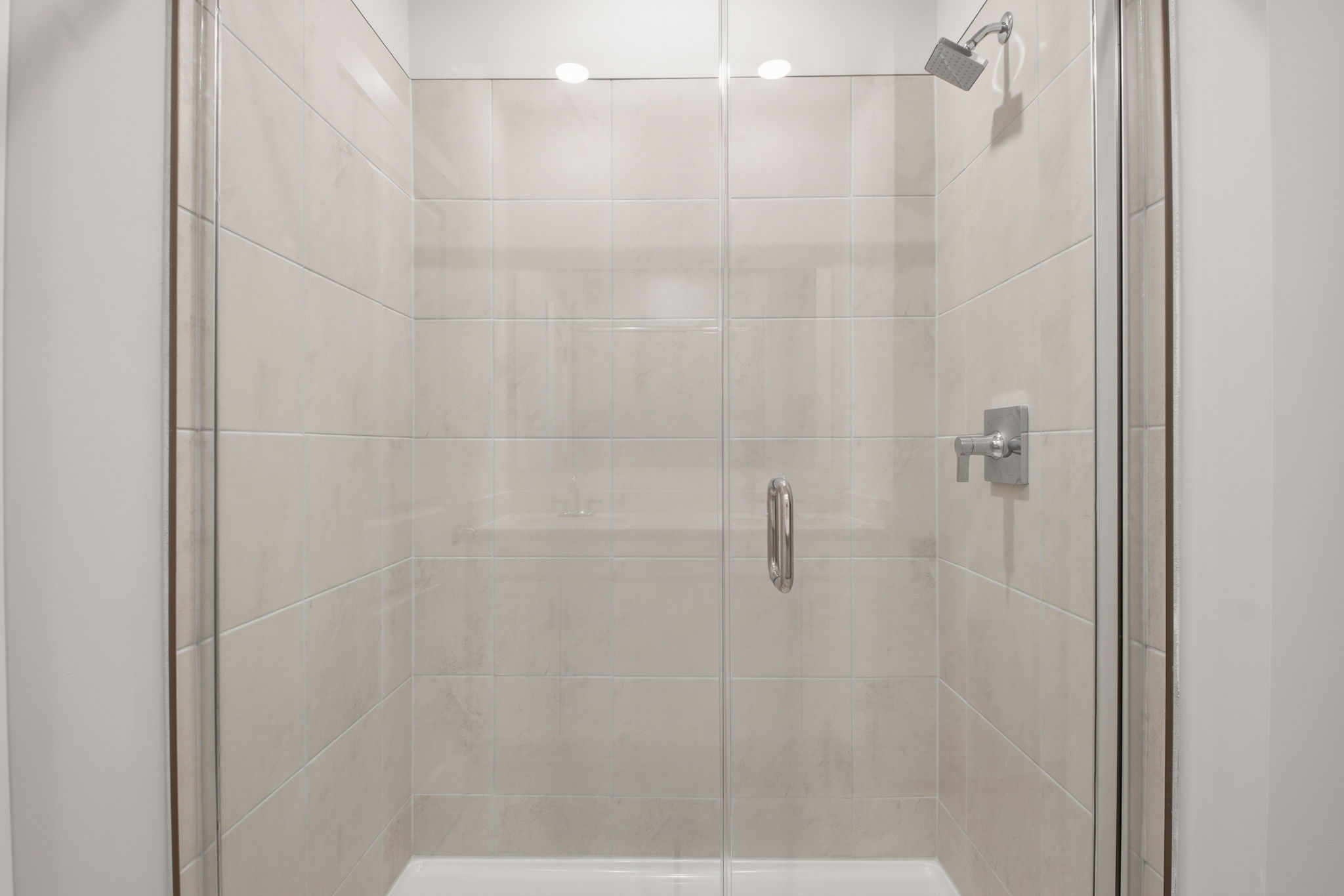 A shower with a glass door.