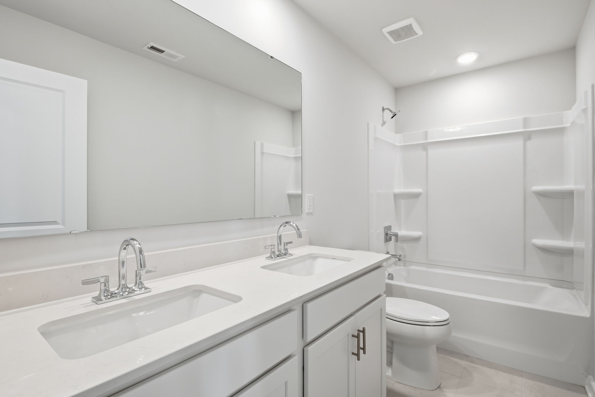 A bathroom with a tub sink and toilet.
