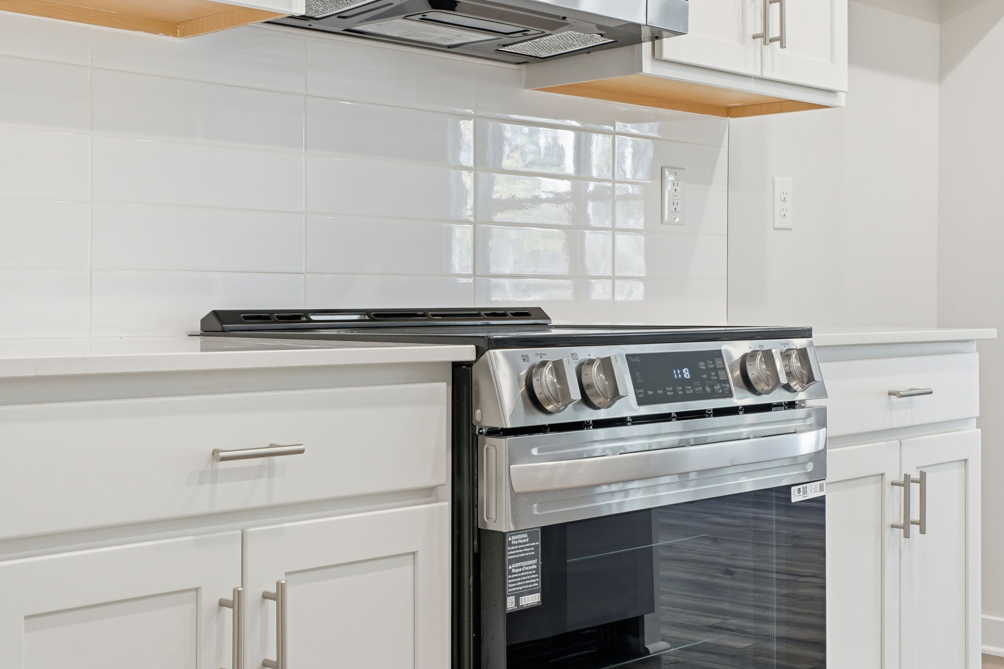 A kitchen with white cabinets.