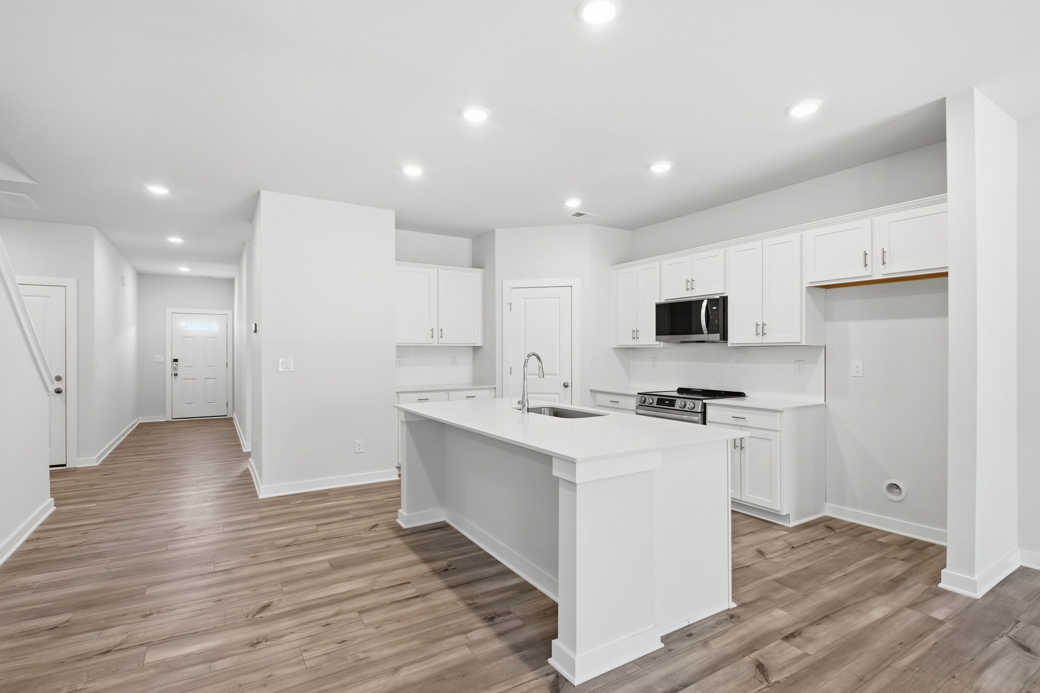 A kitchen with white cabinets.