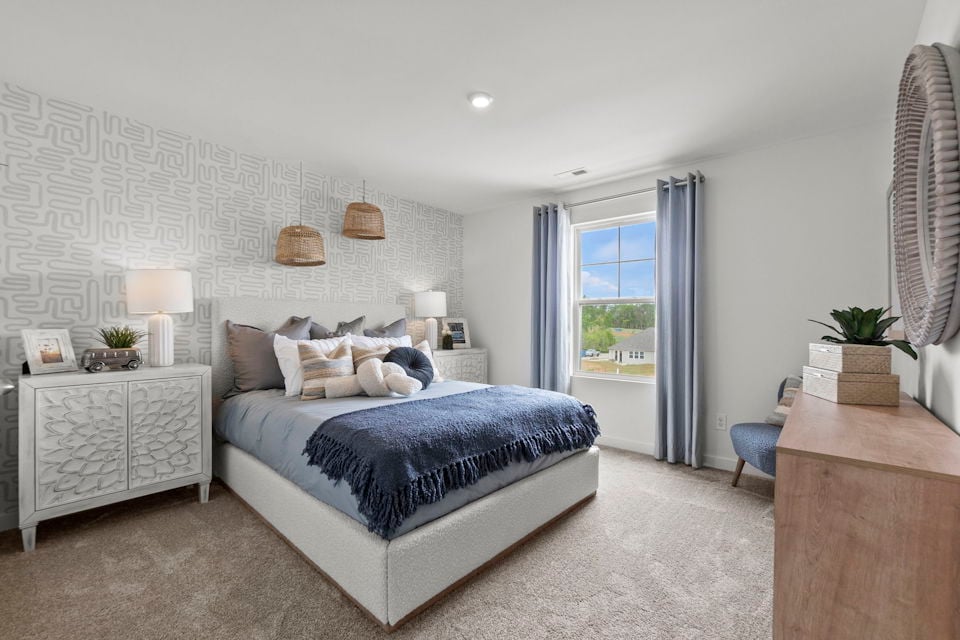 A bedroom with a bed and a desk.