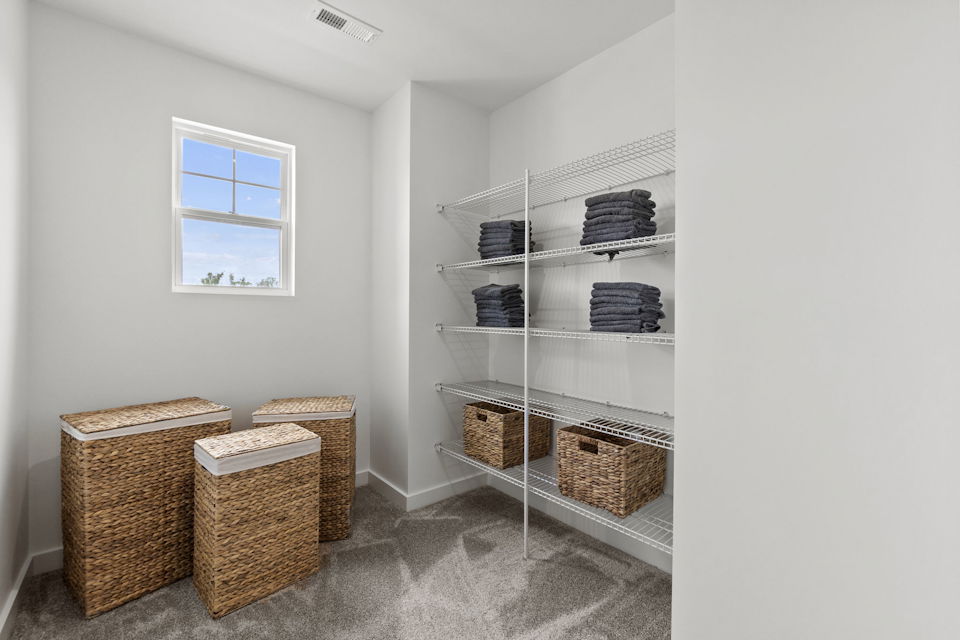 A room with shelves and baskets.