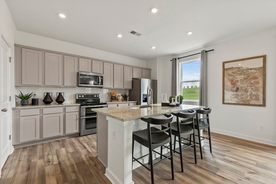 A kitchen with a marble island.