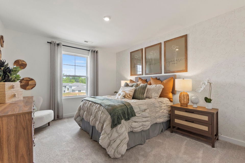 A bedroom with a bed and a table.