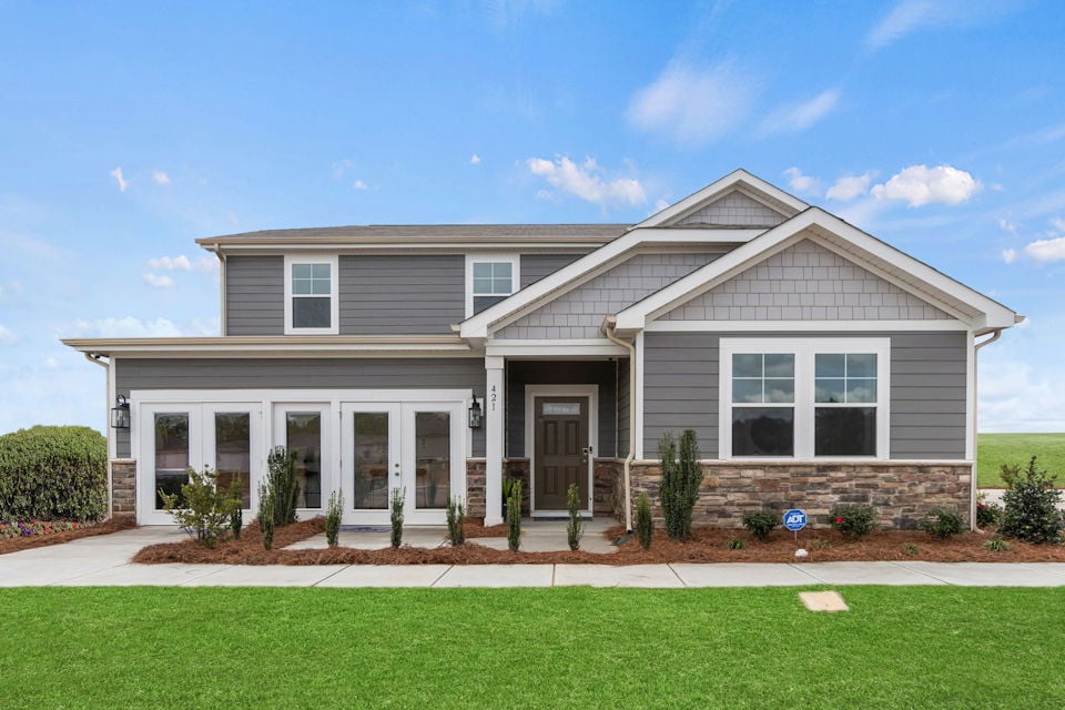 A house with a lawn in front.
