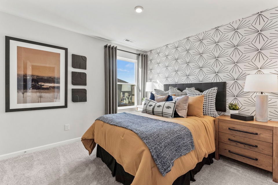 A bedroom with a bed and a window.