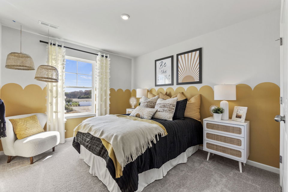 A bedroom with a bed and lamps.