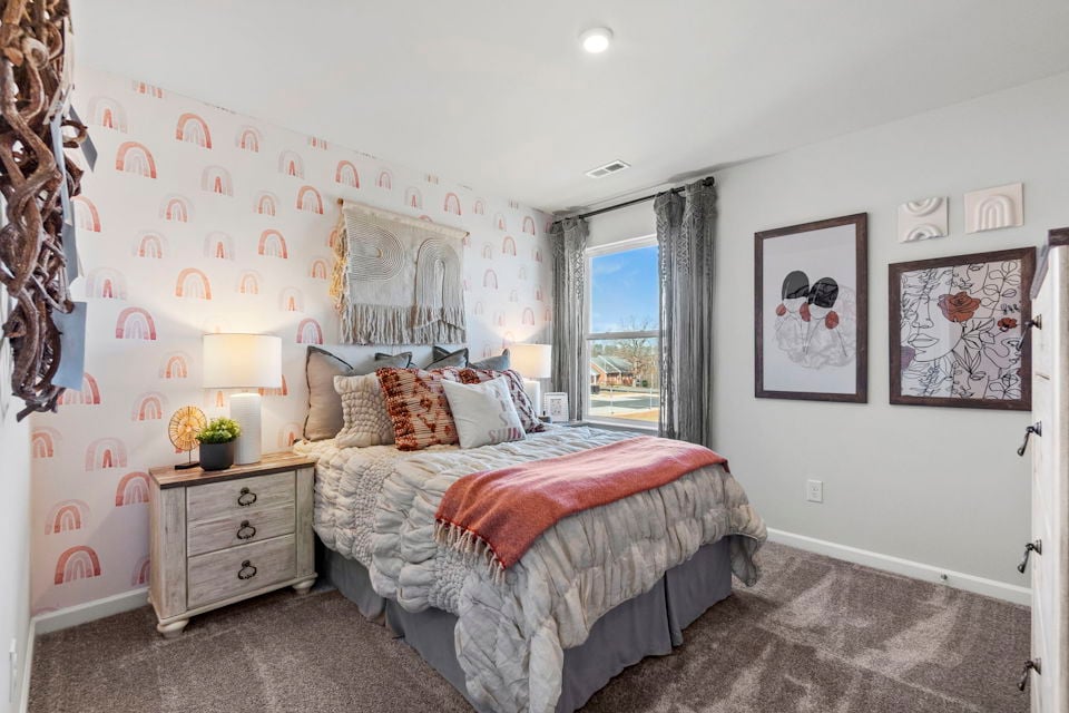 A bedroom with a bed and a window.