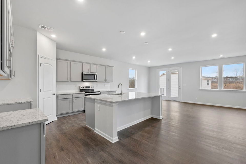 A kitchen with white cabinets.