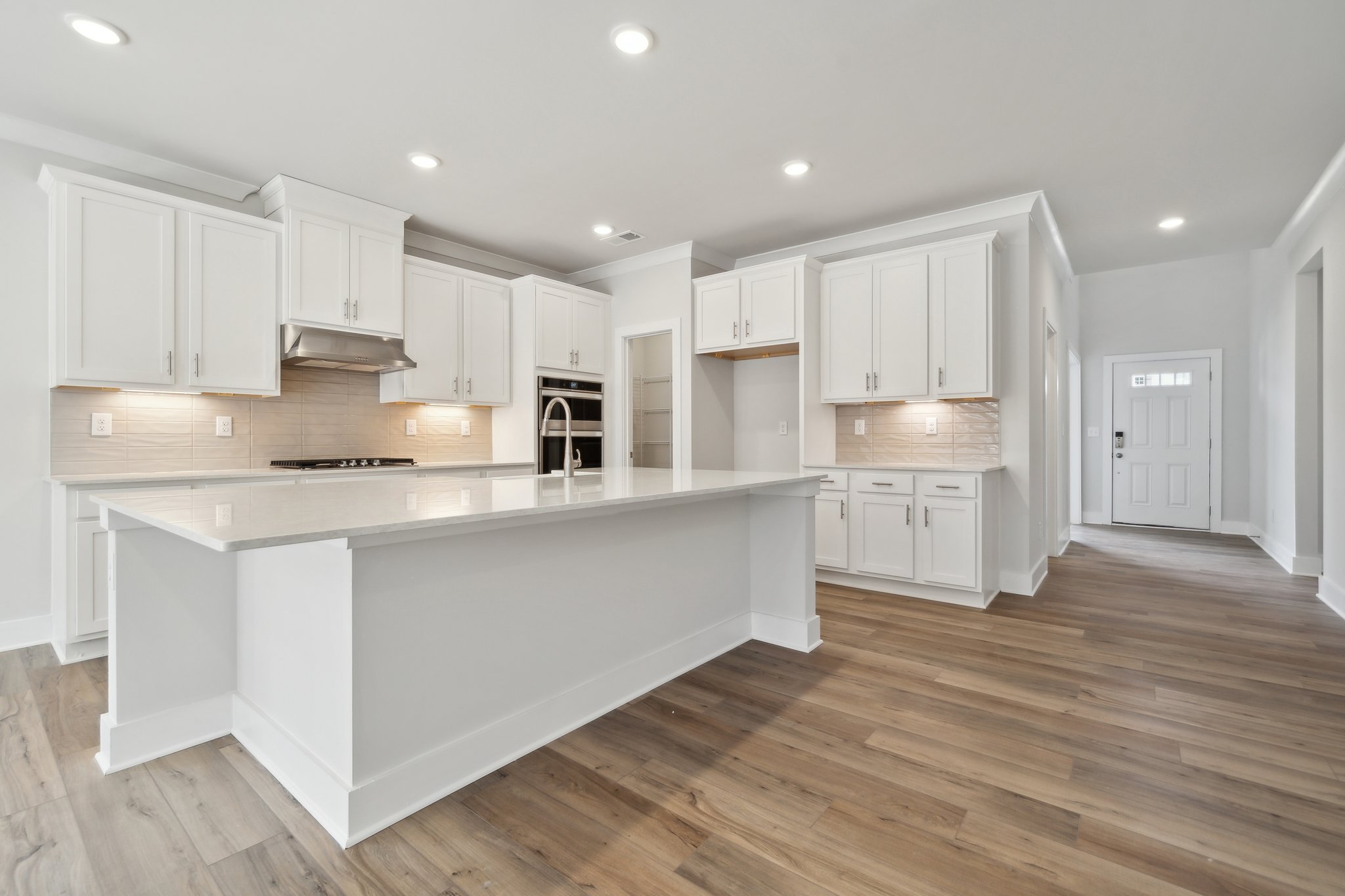 A kitchen with white cabinets.
