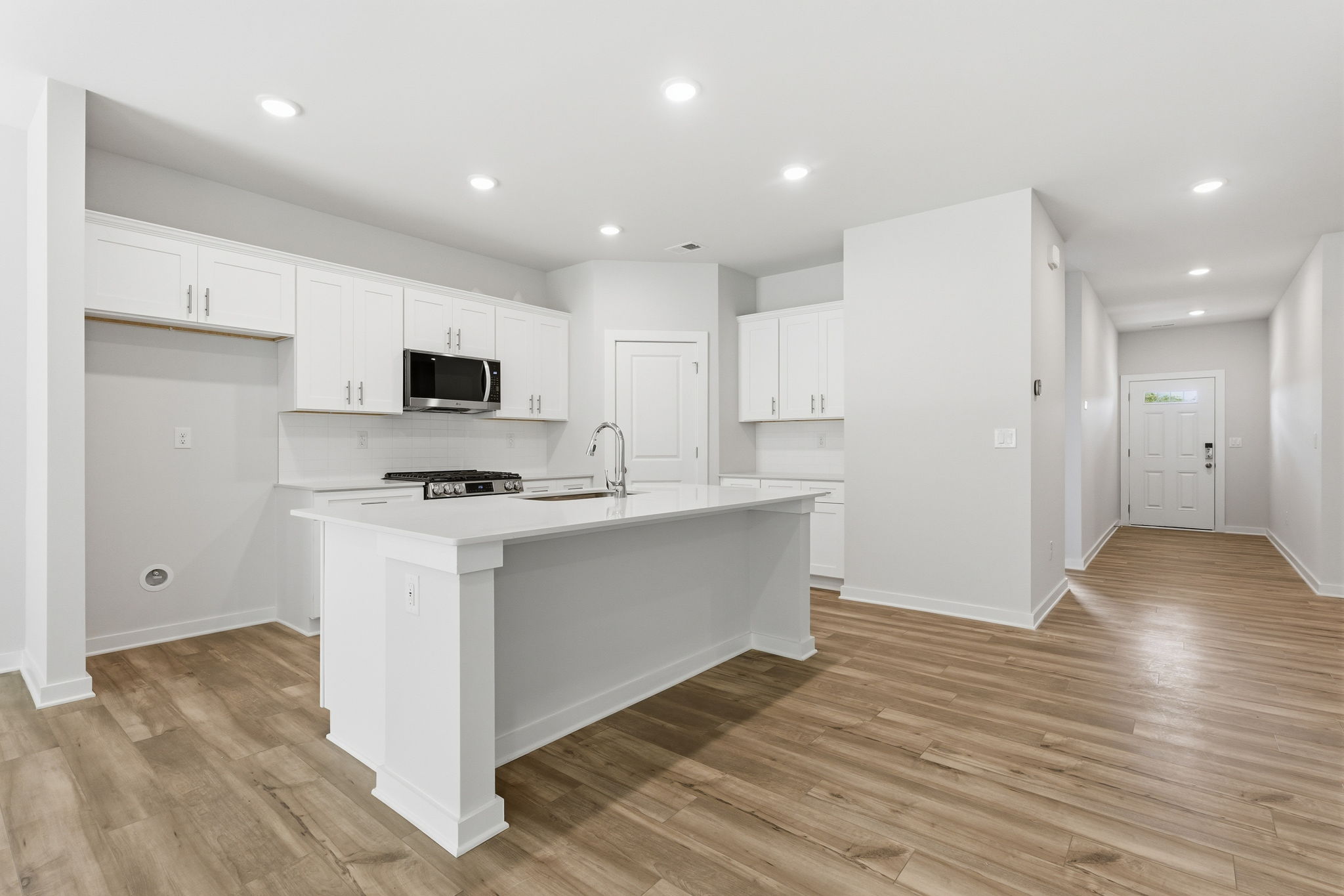 A kitchen with white cabinets.