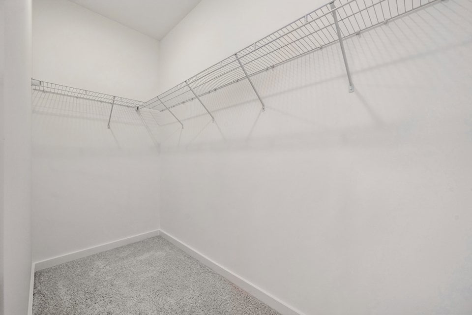 A white wall with a metal bar.