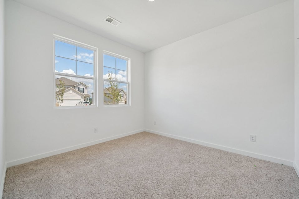 A room with a window and a carpet.
