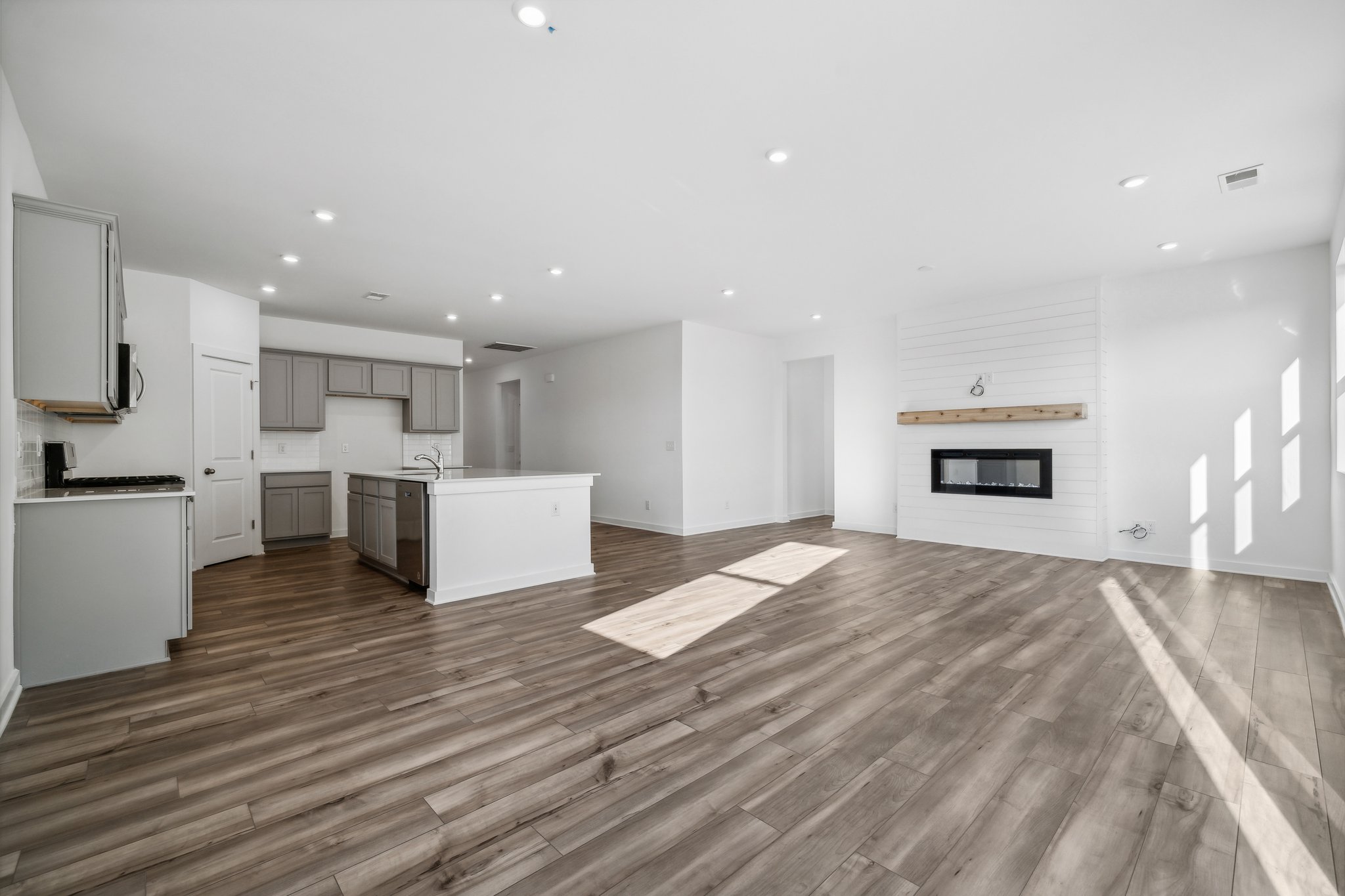 A large kitchen with wood floors.
