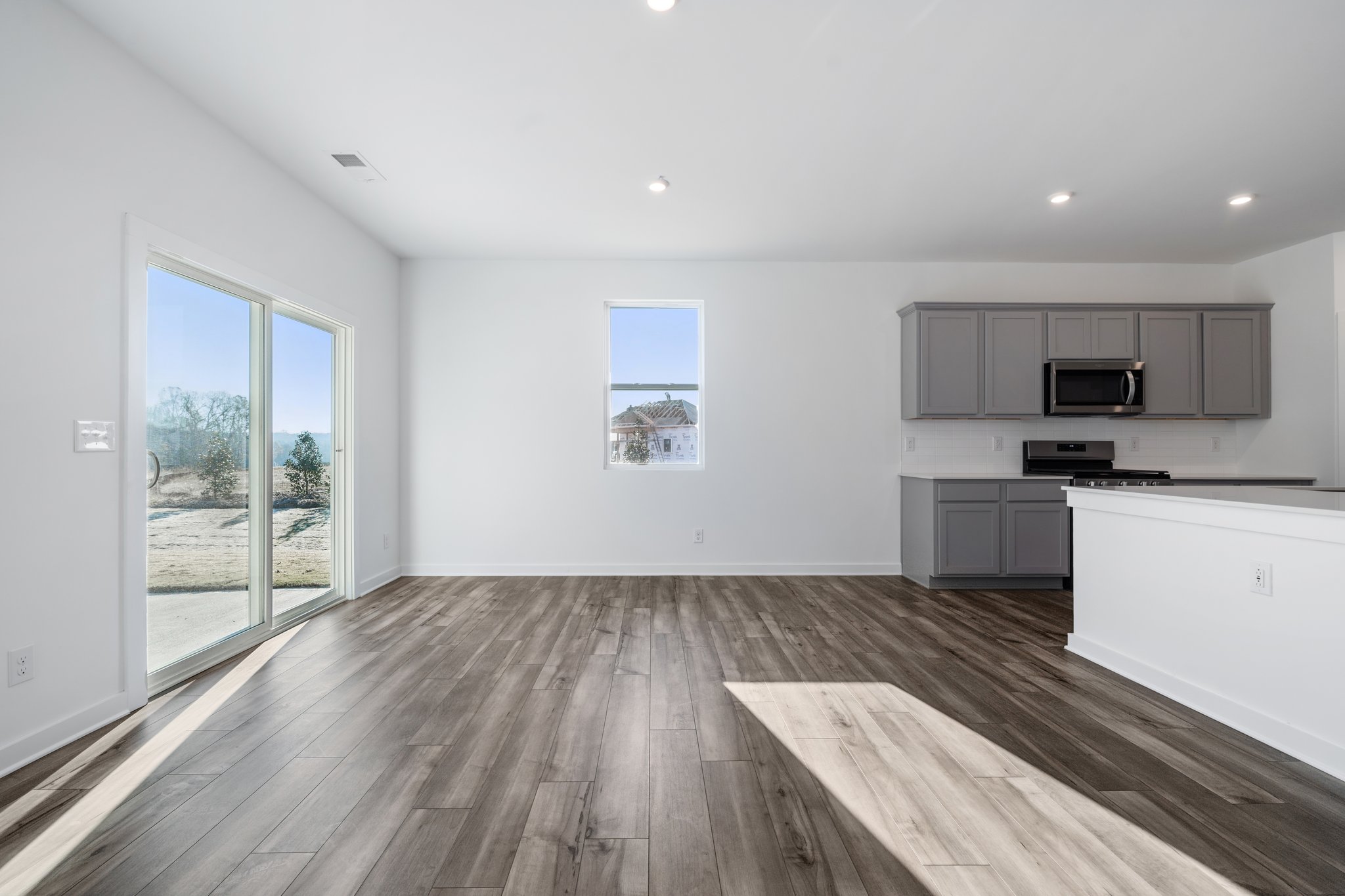 A kitchen with a wood floor.