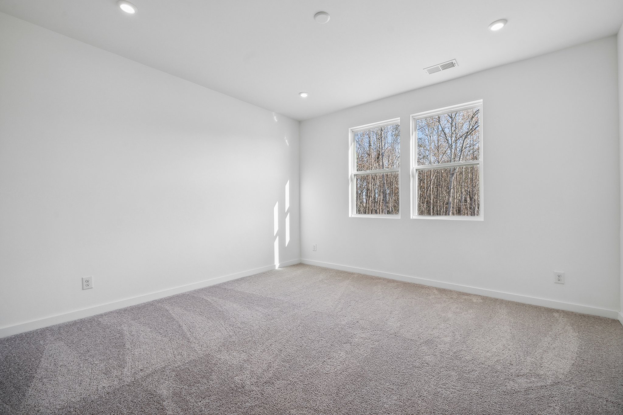 A room with a few paintings on the wall.