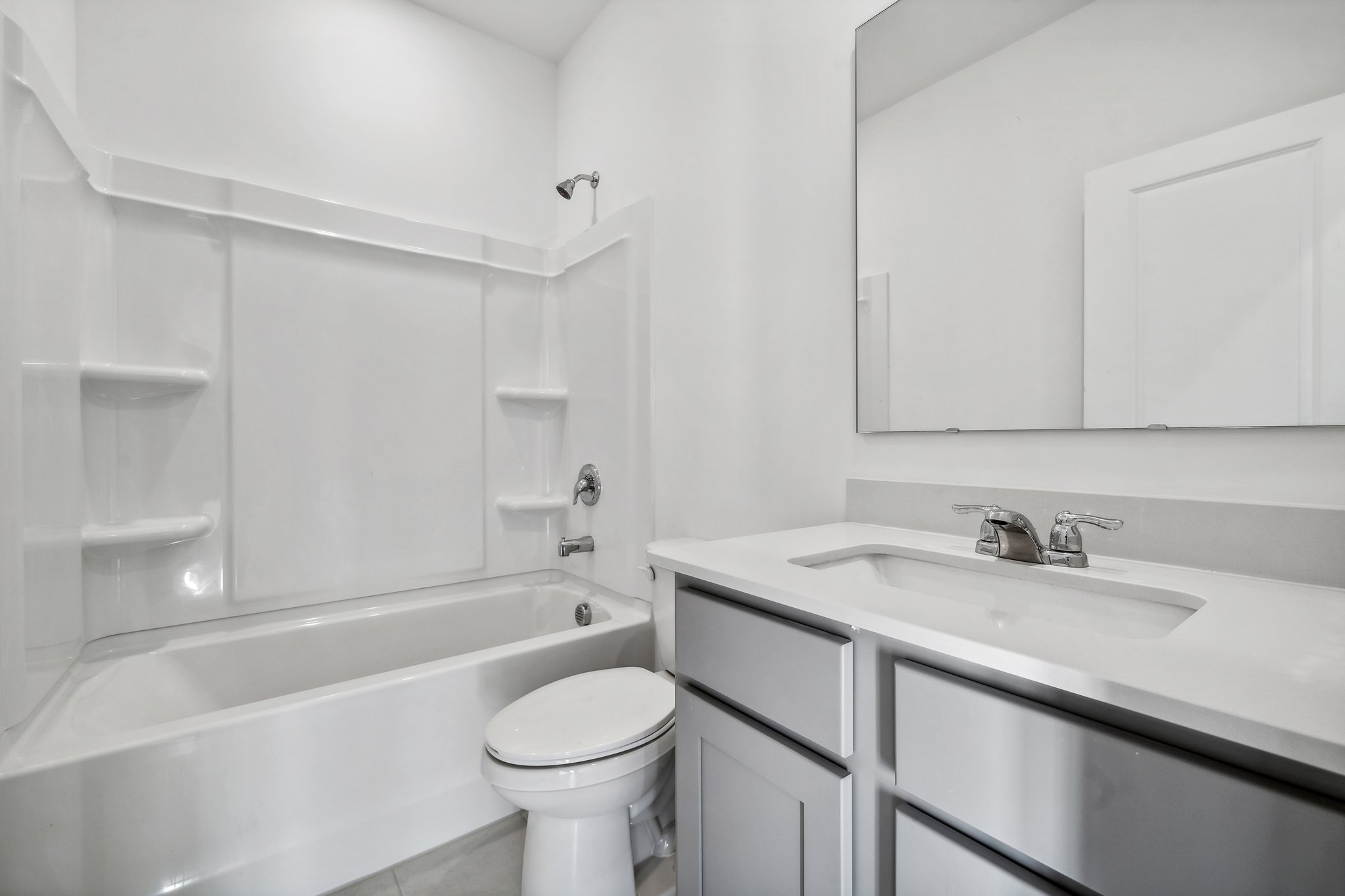 A bathroom with a tub sink and toilet.