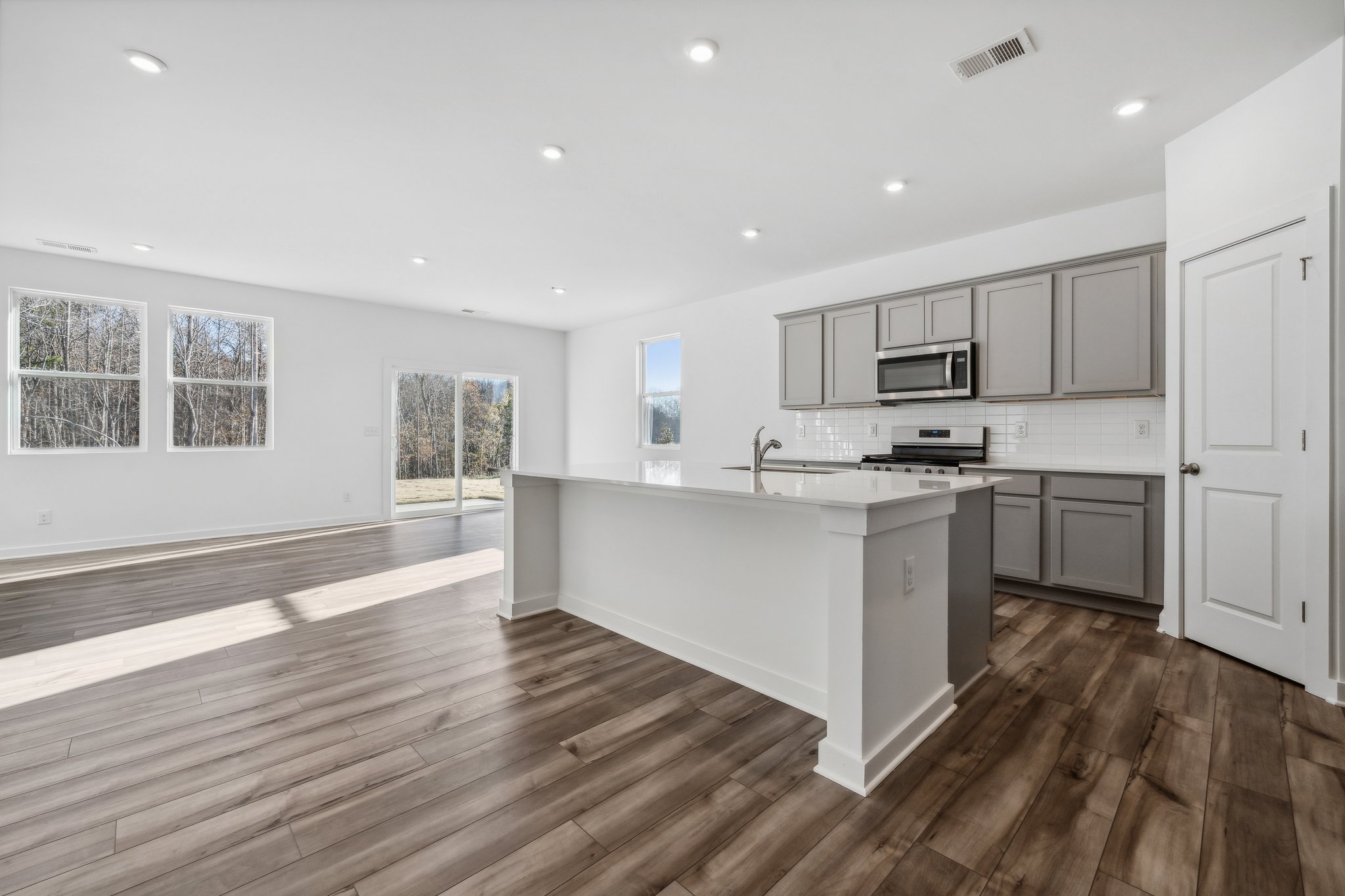 A kitchen with white cabinets.