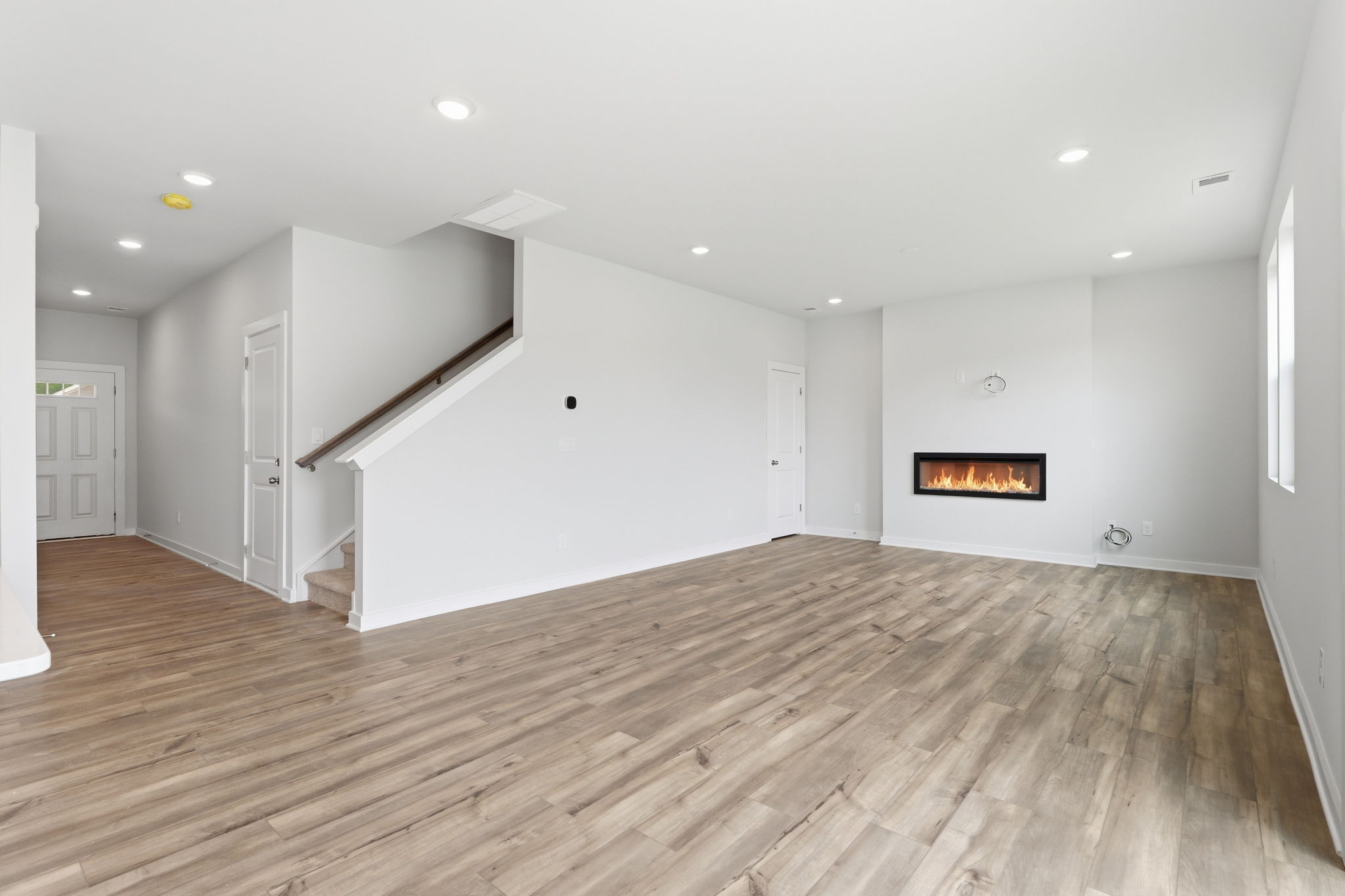 A room with a wood floor and white walls.