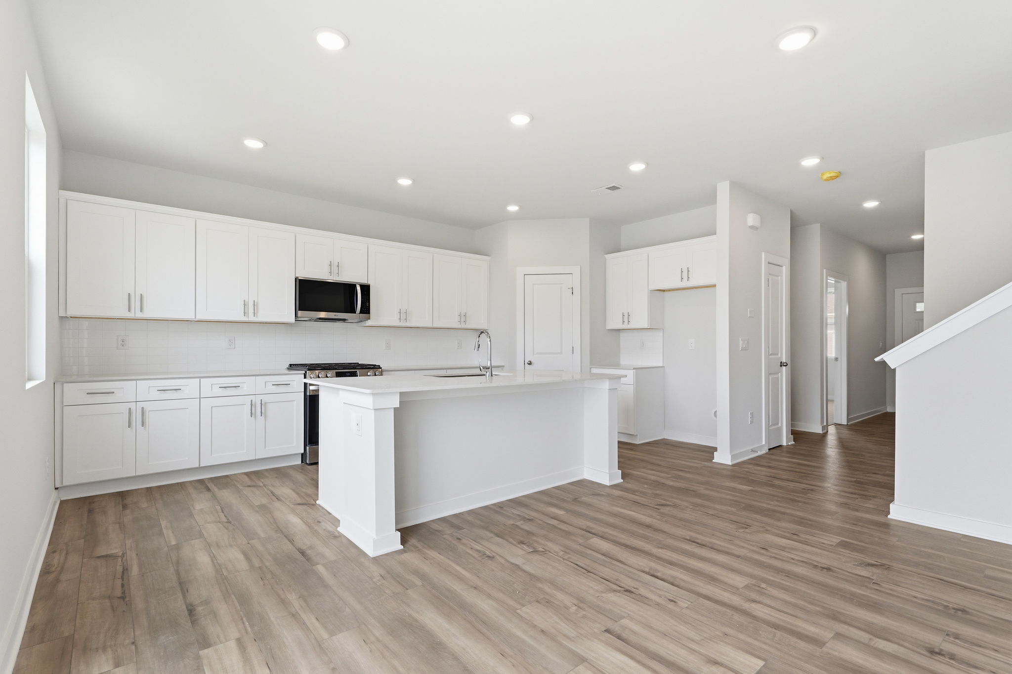 A kitchen with white cabinets.