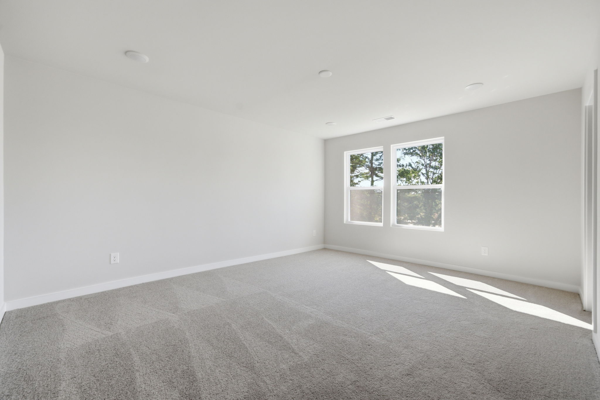 A room with a window and a carpet.