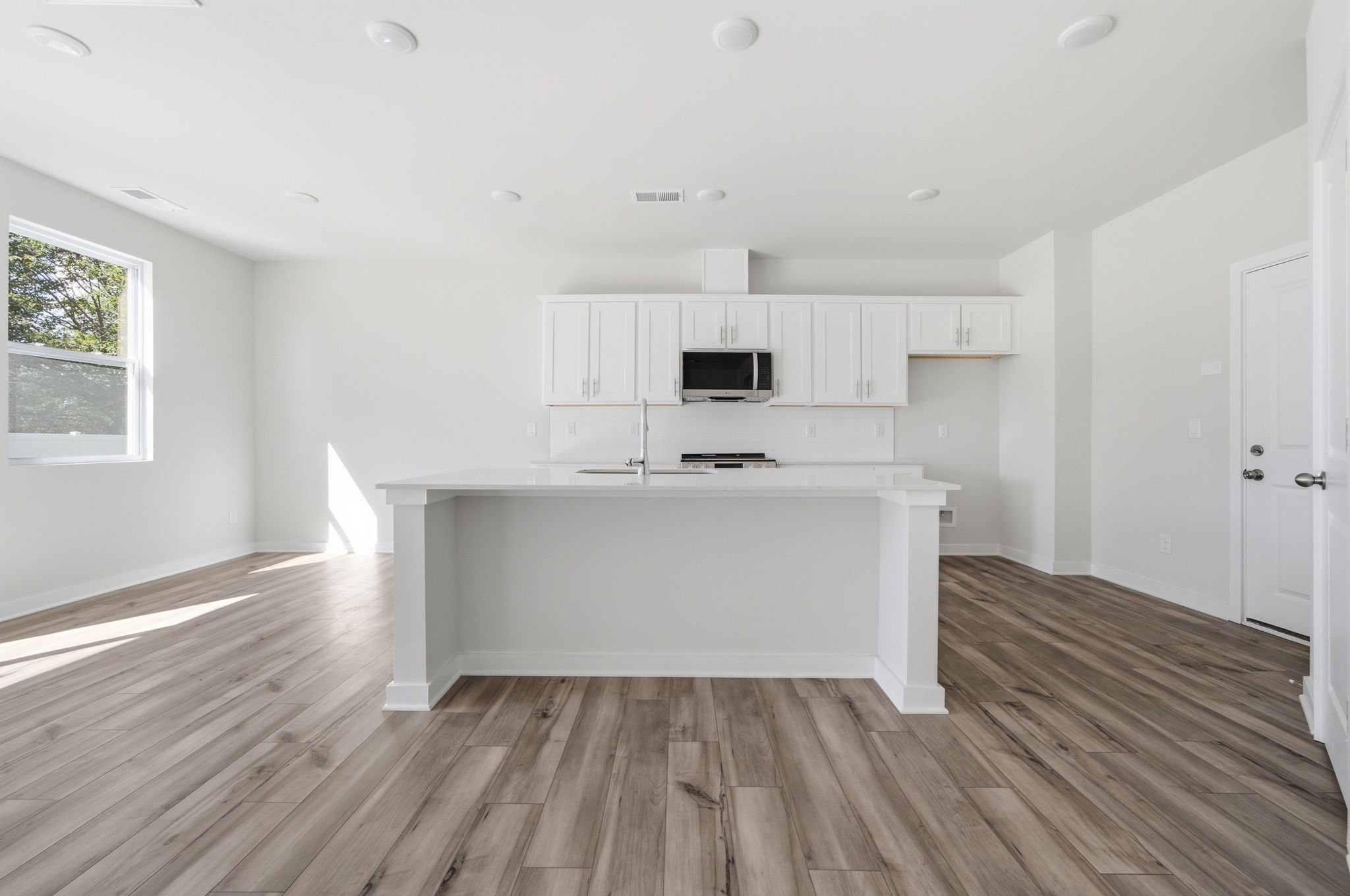 A kitchen with white cabinets.