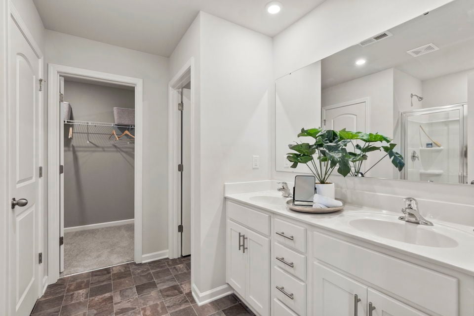 A bathroom with a sink and a shower.